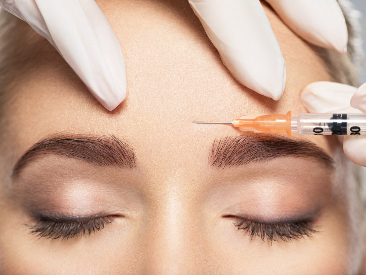 Woman getting cosmetic injection of botox