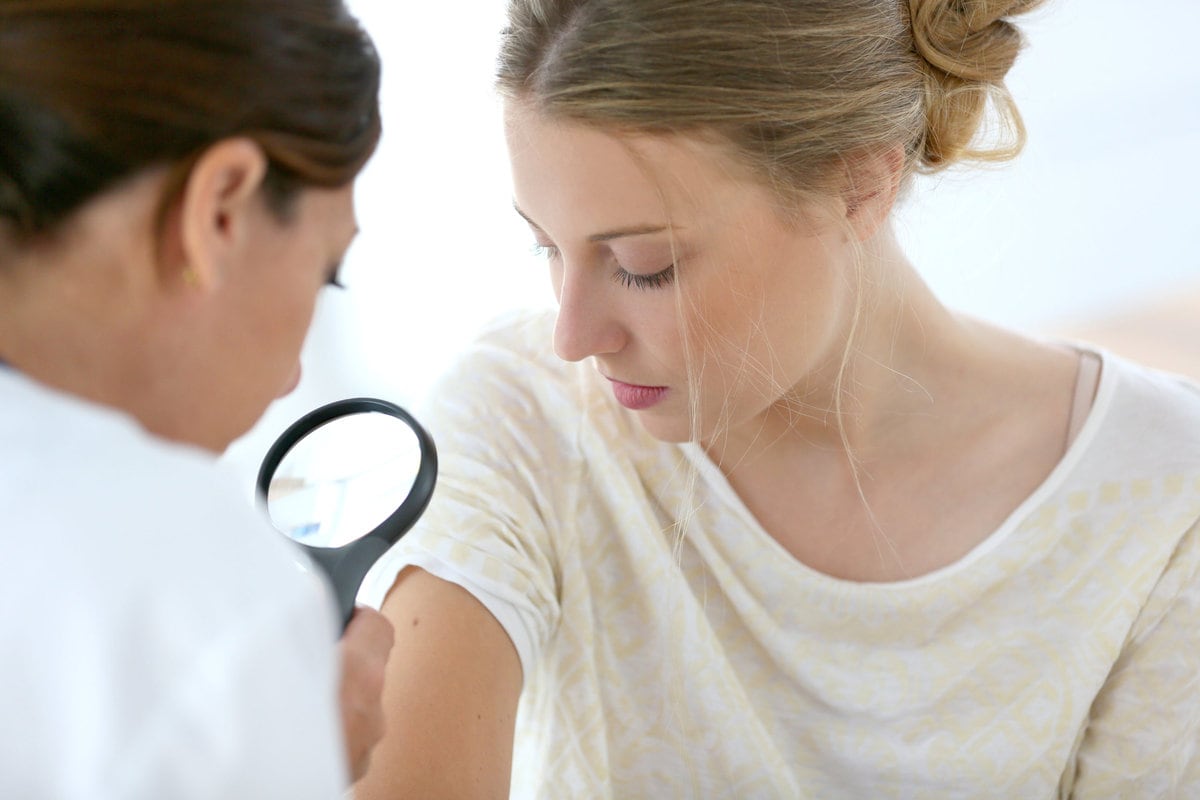 Young woman seeing doctor for dermatological control
