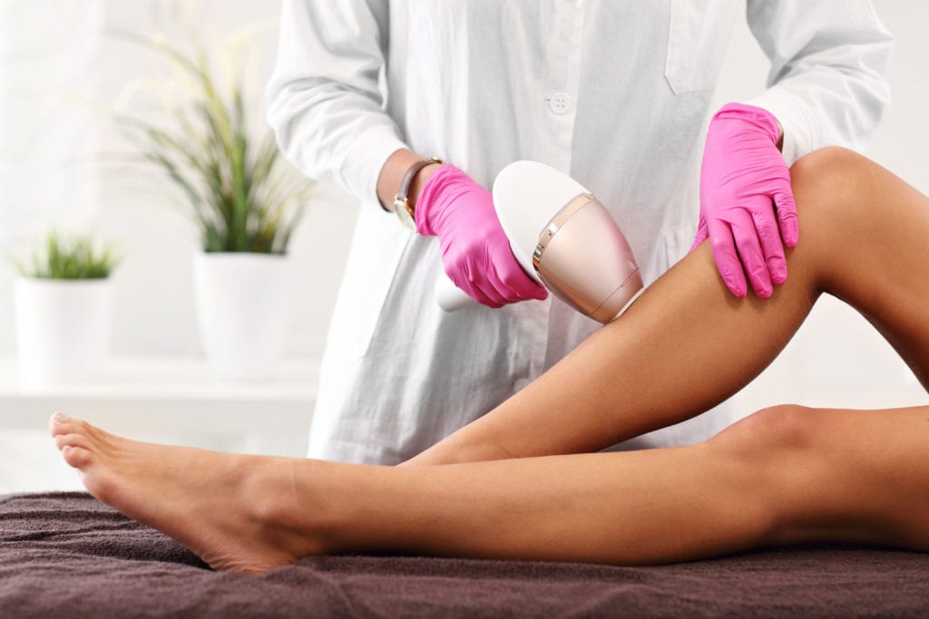 woman having laser hair removal in professional beauty salon